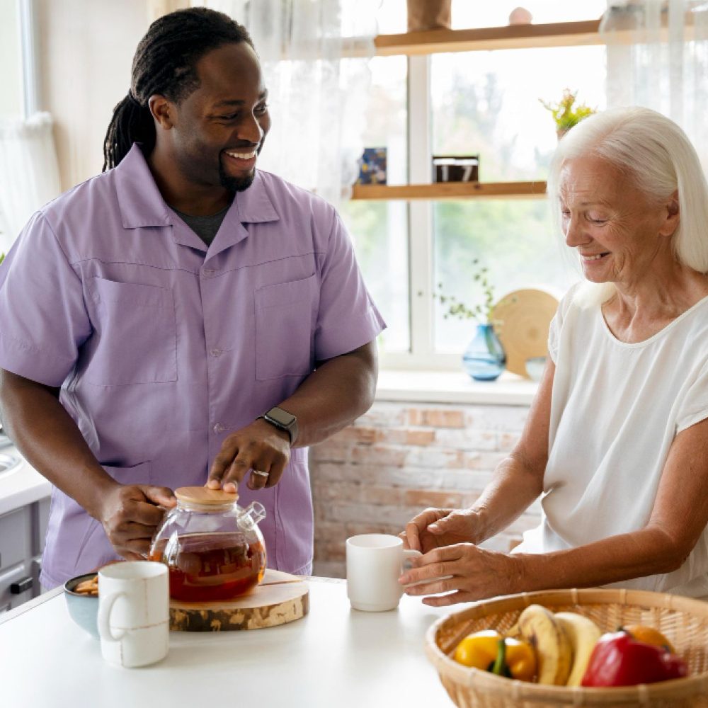 Caregiver serving tea to elderly woman.