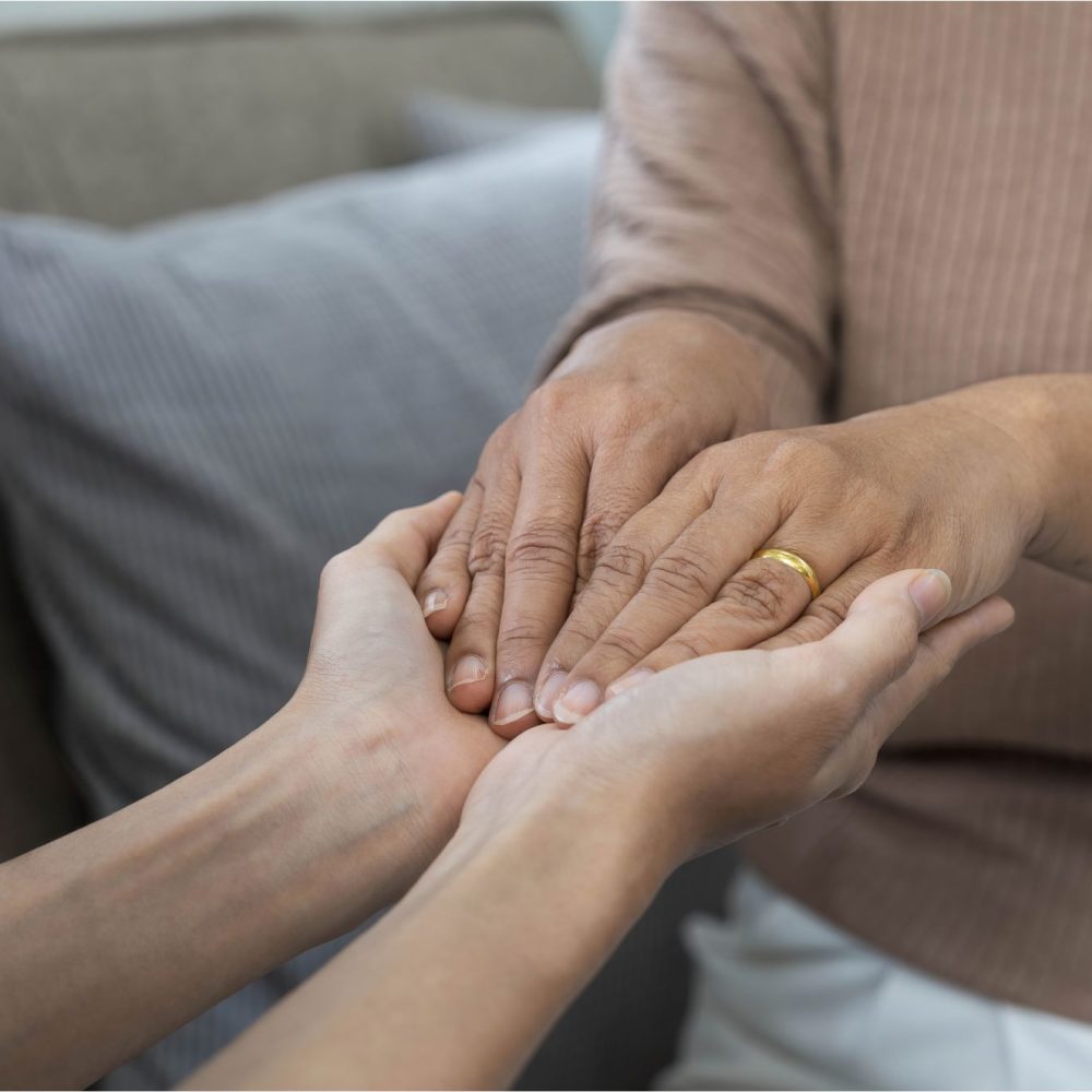 Two hands holding each other gently.